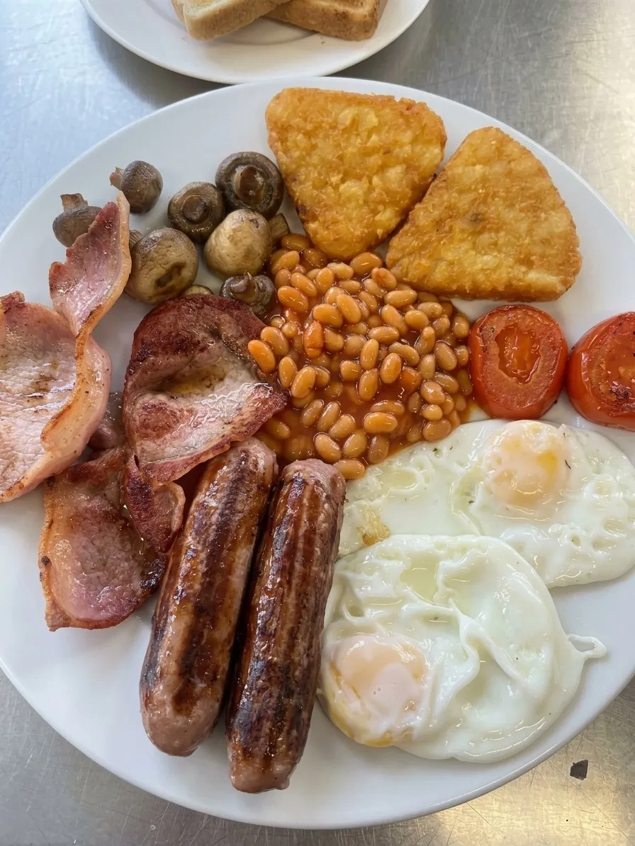A large full English breakfast with hash browns, mushrooms and eggs