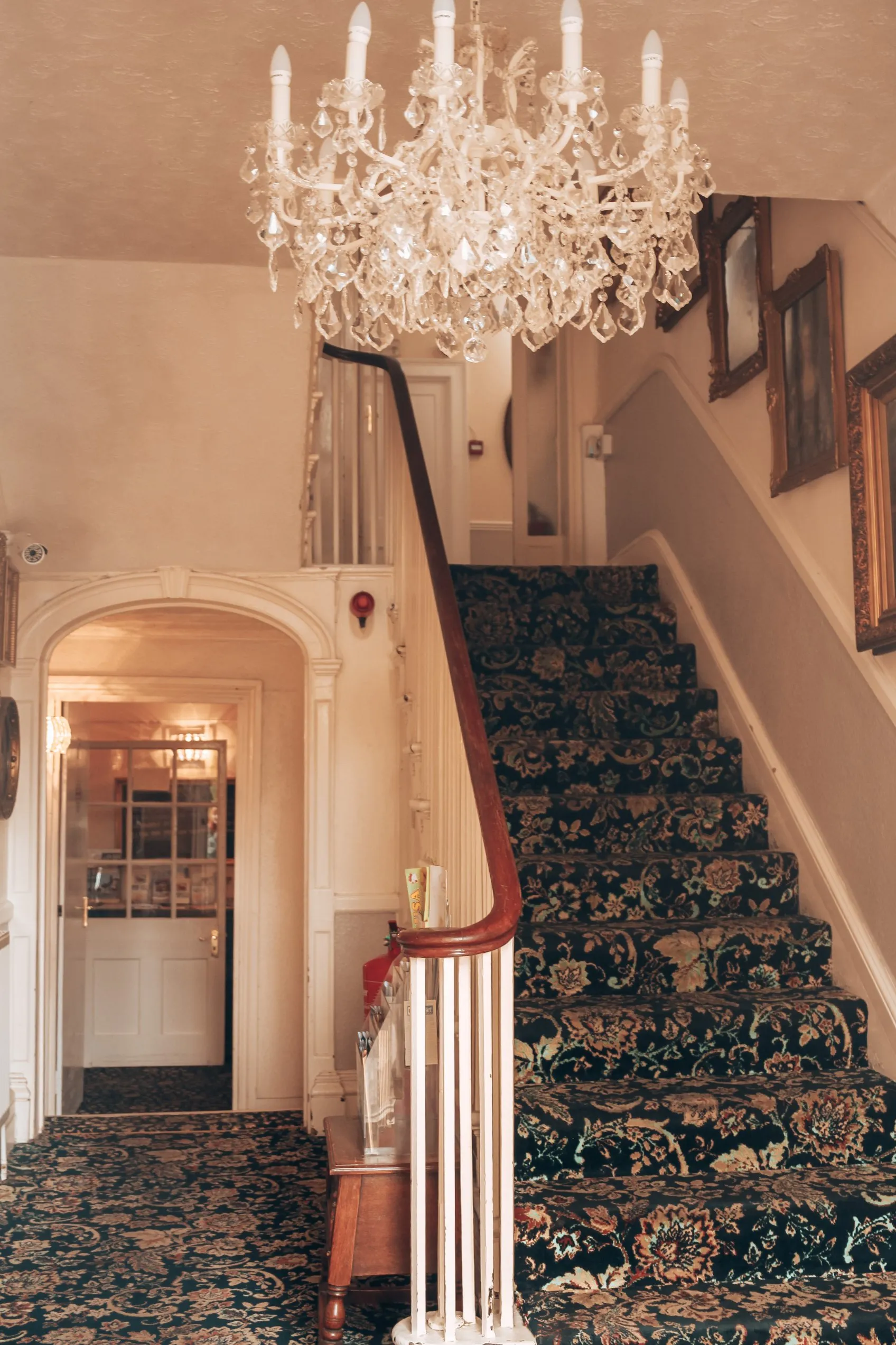 The hall and staircase under a chandelier