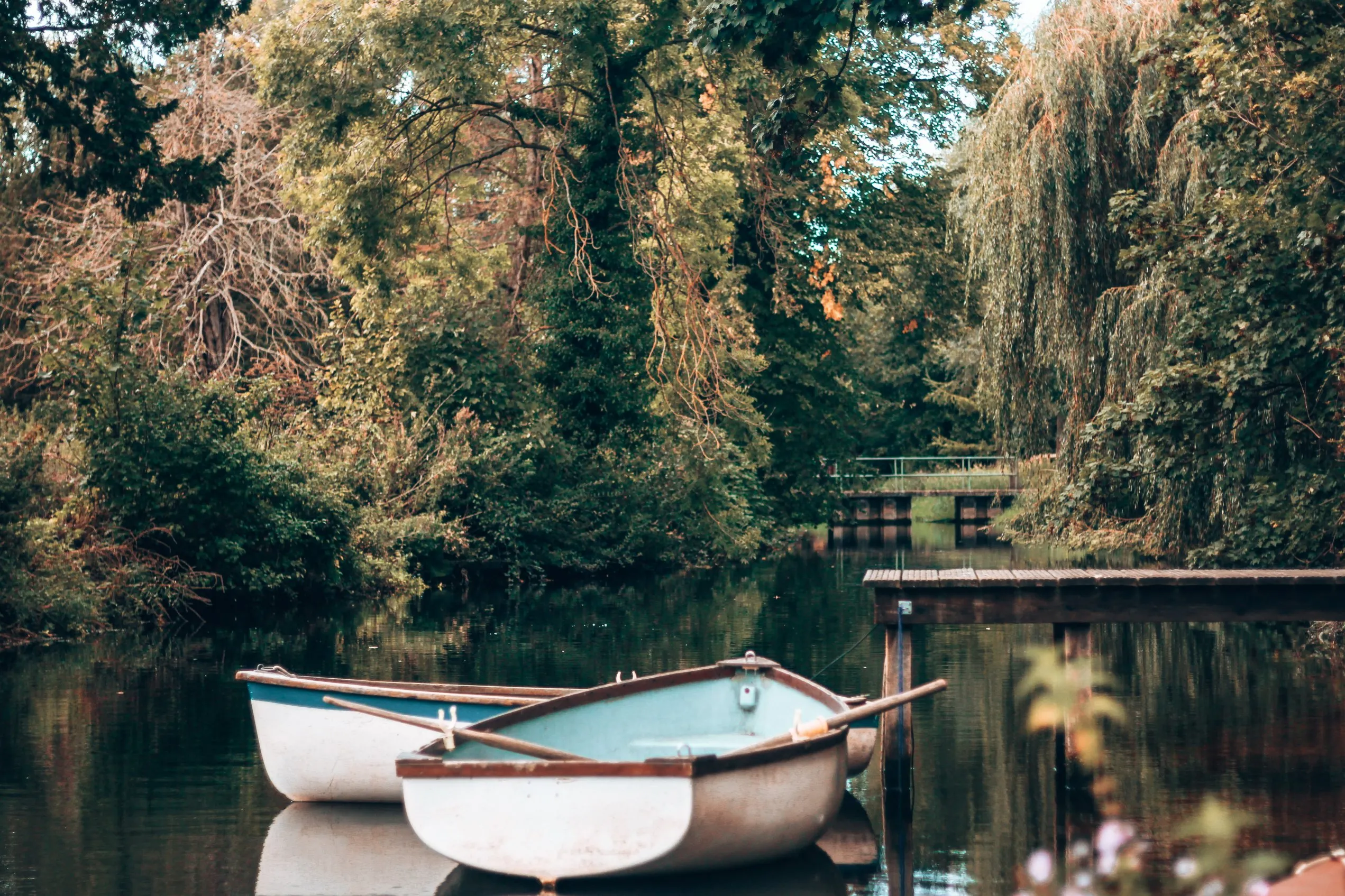 Rowing boats moored on the river by the hotel garden