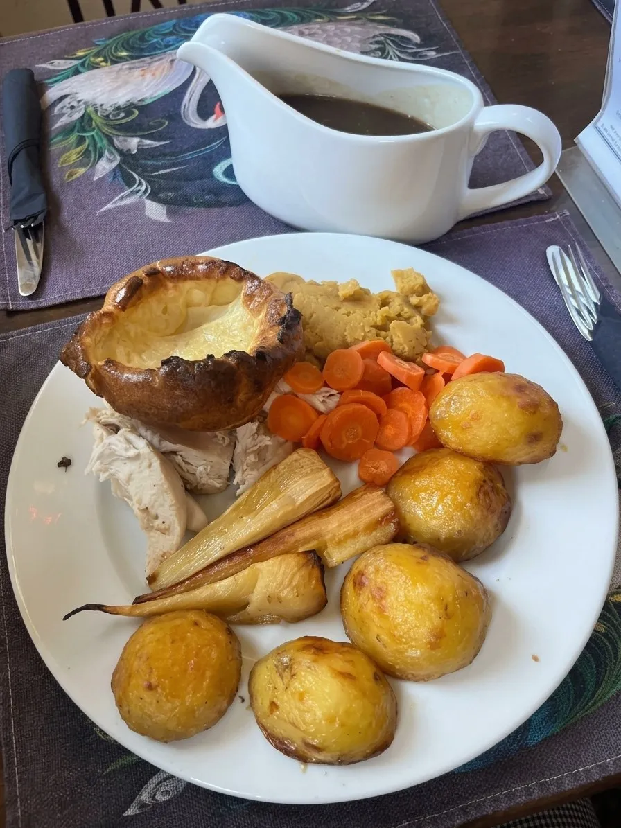Roast dinner with a Yorkshire pudding, roast potatoes, parsnips and carrots